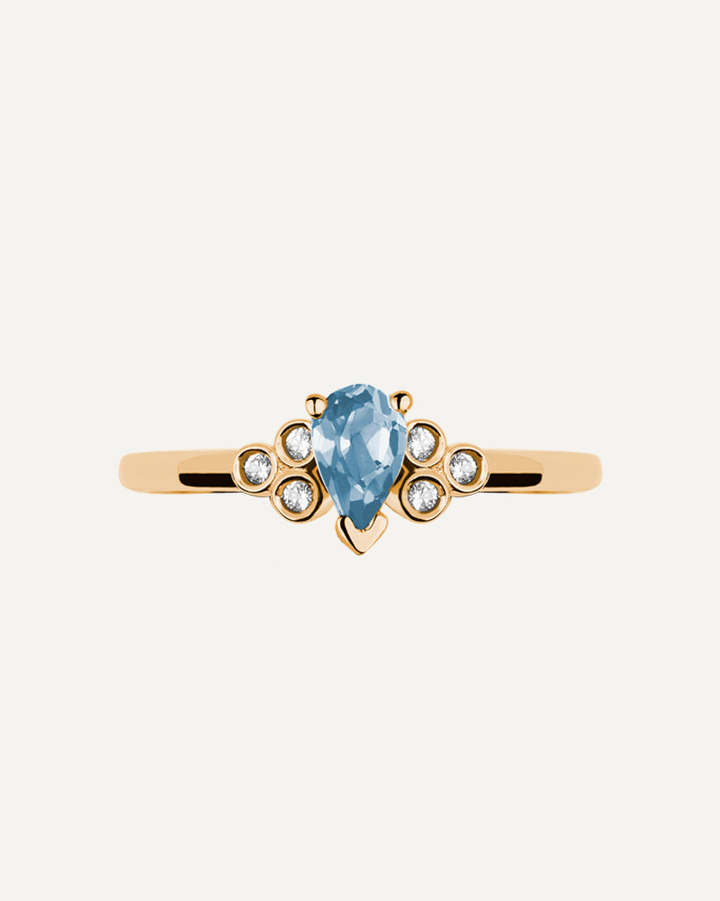 Anillo Petite en plata de ley con baño de oro y con topacio Sky en talla perilla y topacios blancos