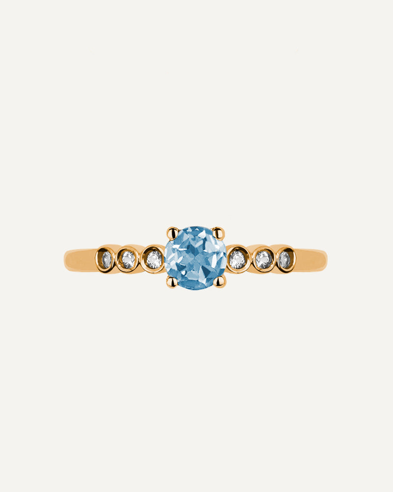 Anillo Petite en plata de ley con baño de oro y con topacio Sky en talla redonda y topacios blancos