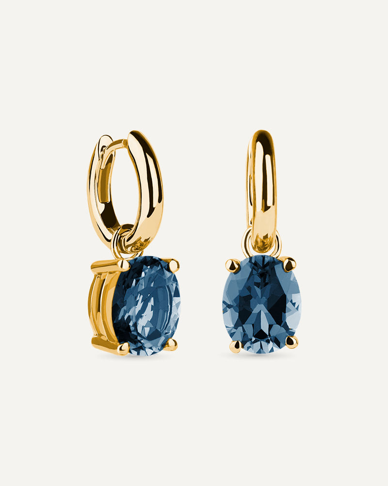 Pendientes Luxe en plata de ley con baño de oro y con topacio London Blue en talla oval.